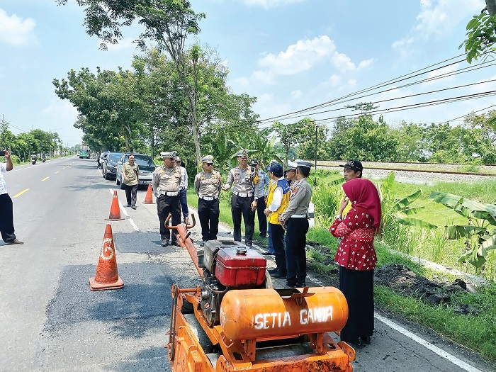 Petugas satlantas dan dinas terkait mengecek kondisi Jalan Raya Nganjuk-Kertosono.