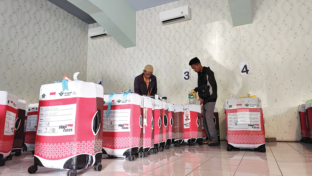 CARI KOPER: Keluarga jemaah haji mengambil koper di Aula Kantor Kemenag Nganjuk kemarin. Satu koper jemaah haji asal Kecamatan Badas, Kabupaten Kediri terbawa ke Nganjuk.