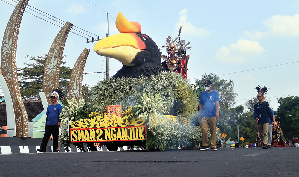 MEMUKAU: SMA Negeri 2 Nganjuk menampilkan mobil hias dengan replika Burung Enggang khas Pulau Kalimantan saat Pawai Budaya dan Pawai Pembangunan Nganjuk di Jalan Ahmad Yani Nganjuk.
