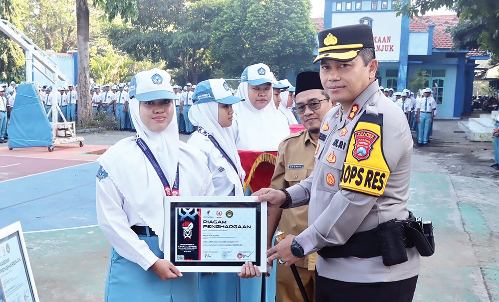 BERPRESTASI: Kapolres Nganjuk AKBP Henri Noveri Santoso memberi penghargaan pada Anisa Nur Aditris yang meraih juara olimpiade.