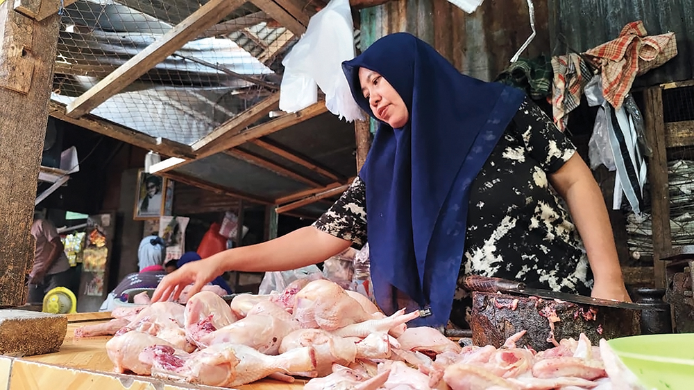 SEPI PEMBELI: Pedagang ayam di Pasar Wage Nganjuk menata dagangannya. Harga ayam melonjak bikin sepi.