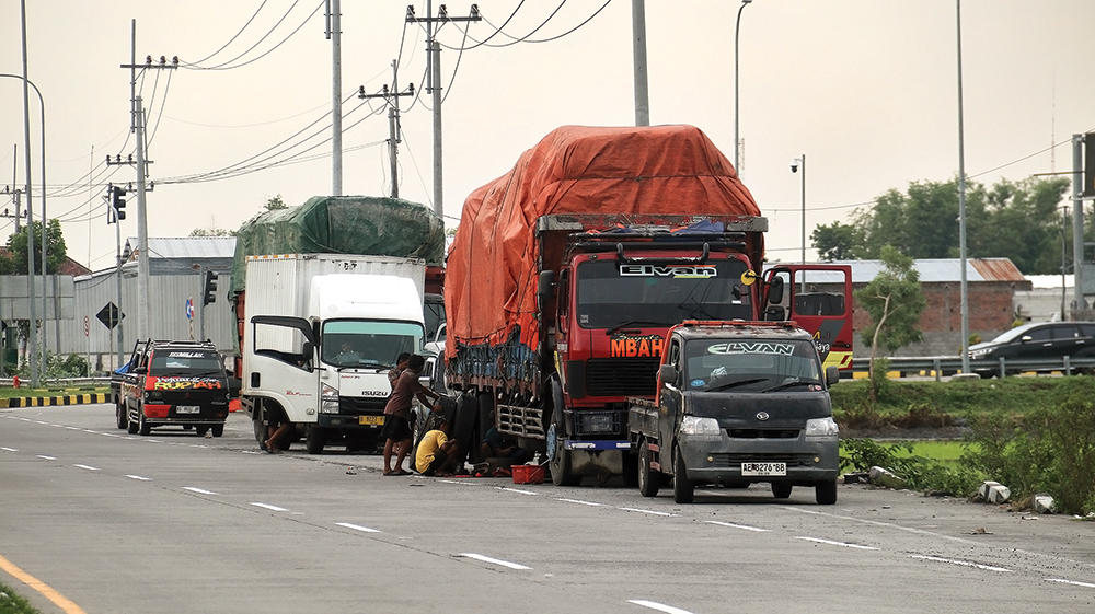 TUNGGU SOLAR: Sopir truk dan pikap parkir di tepi jalan raya dekat SPBU Werungotok karena stok solar kosong.