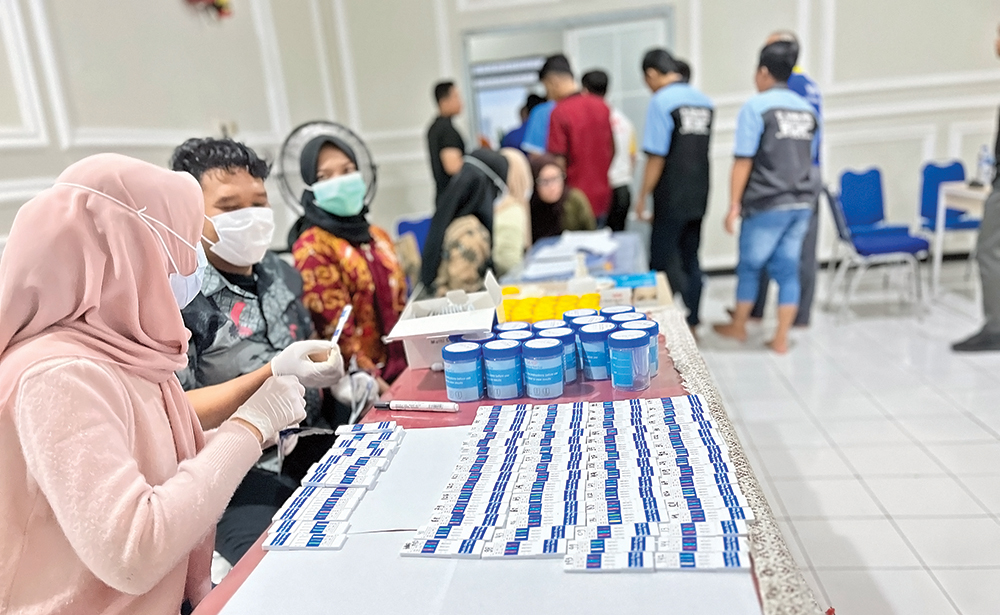TES URINE: Petugas mengecek urine warga binaan kasus narkoba di Rutan Kelas IIB Kabupaten Nganjuk kemarin.