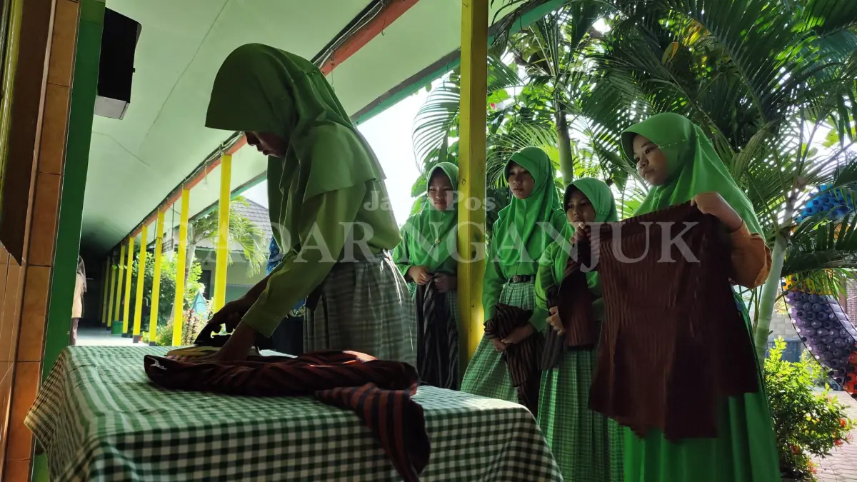 Siswi SDN 1 Ploso menyetrika seragam di sekolah