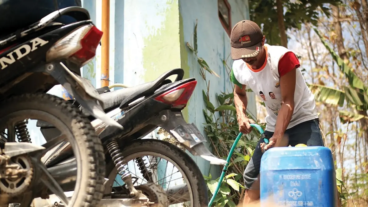 KESULITAN AIR BERSIH: Warga di Desa Ngepung, Kecamatan Lengkong mengisi jerigen dengan air bersih dari tandon. Warga di Kecamatan Lengkong butuh dropping air bersih untuk kebutuhan sehari-hari. (karen wibi/jprk)