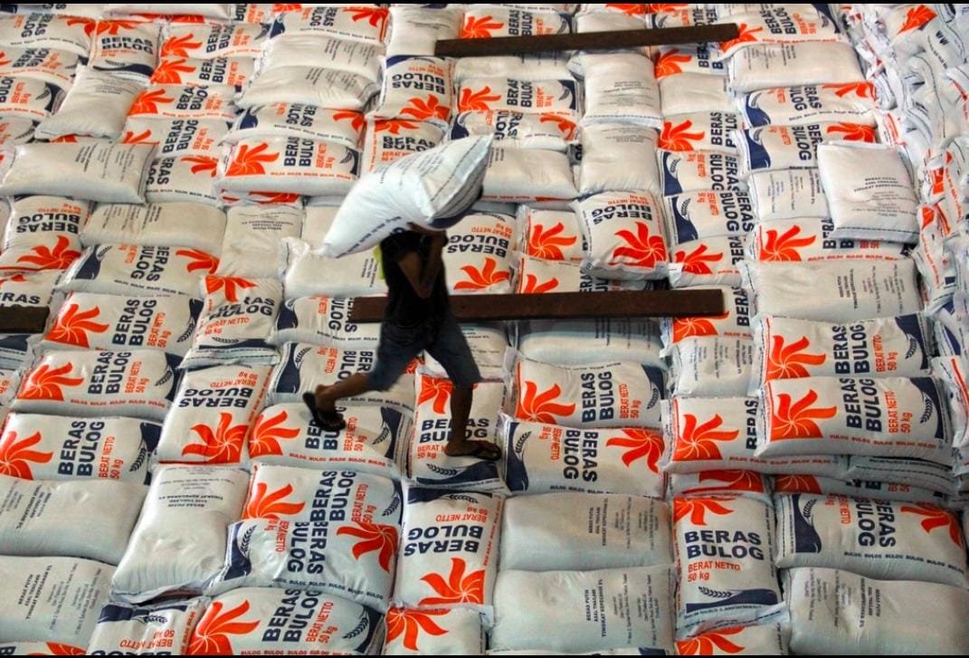 ILUSTRASI: Pekerja mengangkut stok beras di salah satu gudang yang dimiliki oleh BUMN pangan tersebut.