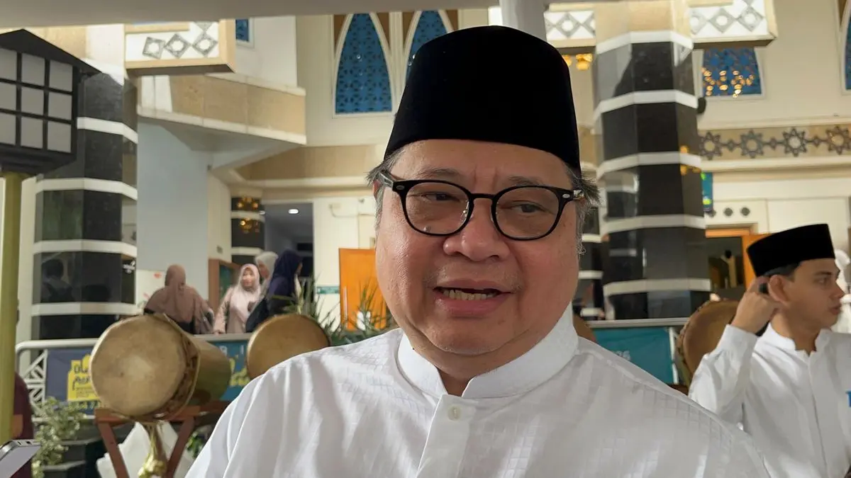 Menko Perekonomian Airlangga Hartarto mengenakan peci hitam dan baju koko putih saat memberikan keterangan pers