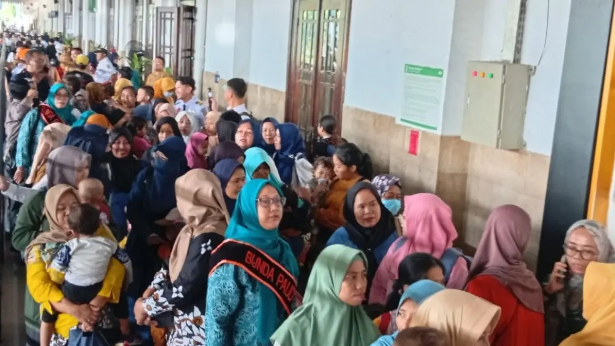 Penumpang kereta api komuter di Stasiun Surabaya Gubeng selama masa libur sekolah, transportasi rel jadi favorit untuk berwisata.