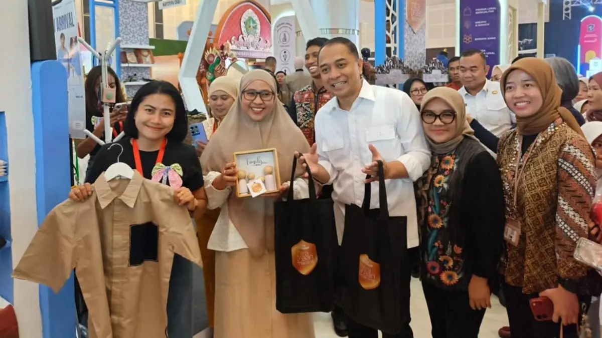 PRODUK KREATIF : Menyemarakkan peringatan Hari Jadi Kota Surabaya ke-733 dalam Surabaya Great Expo (SGE) 2026, Wali Kota Surabaya Eri Cahyadi (tengah) berfoto bersama para pelaku UMKM binaan Pertamina Patra Niaga Regional Jatimbalinus yang memamerkan produk kriya dan kreatif khas Nusantara. (IST/ RADAR SURABAYA)