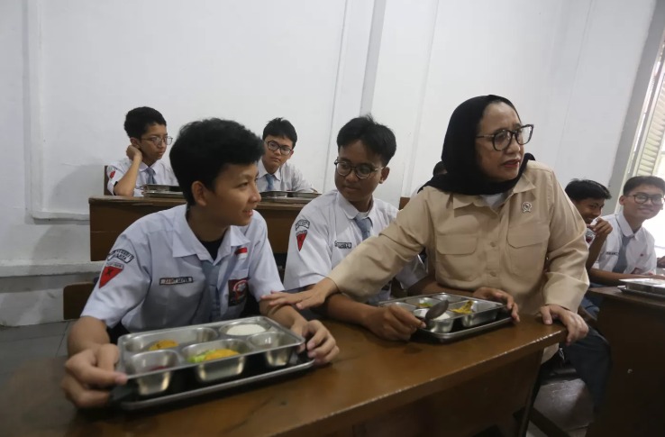 Wakil Kepala Badan Gizi Nasional (BGN) Nanik S Deyang berbincang dengan siswa saat meninjau pelaksanaan program Makan Bergizi Gratis (MBG) di SMK Negeri 1 Jakarta, Kamis (8/1/2026).