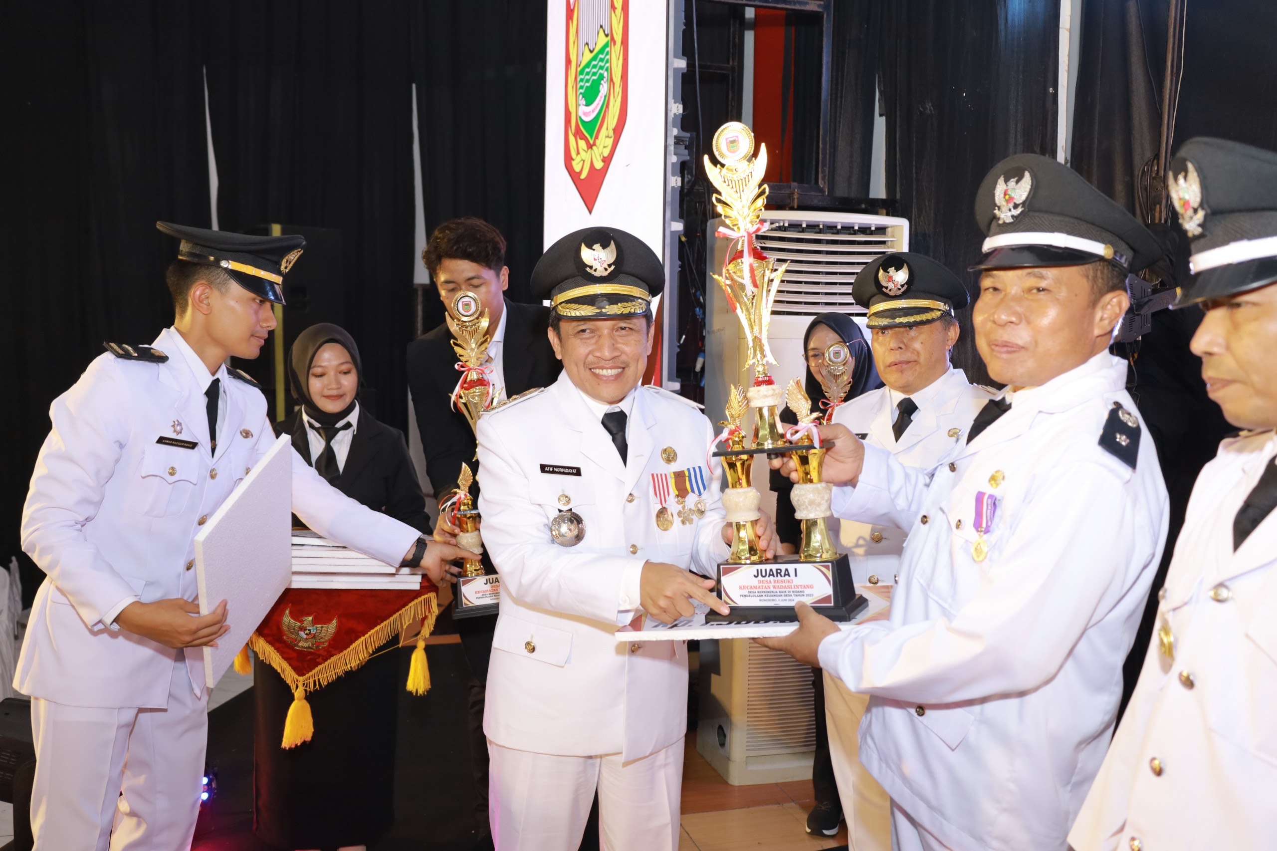 Bupati Wonosobo Afif Nurhidayat disaksikan Wabup Muhammad Albar menyerahkan penghargaan kepada desa terbaik di Sasana Adipura Kencana, Rabu (5/6/2024).