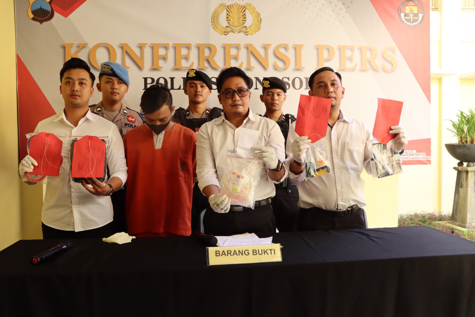 Pelaku pengedar narkoba tertunduk setelah dibekuk oleh aparat kepolisian.
