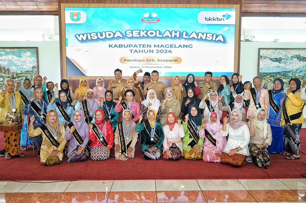 Para lansia berfoto bersama dengan Kepala Dinas Sosial Kabupaten Magelang Bela Pinarsi dan Ketua bidang 2 TP PKK Kabupaten Magelang Siti Juwariya Adi Waryanto saat wisuda di Pendopo drh Soepardi