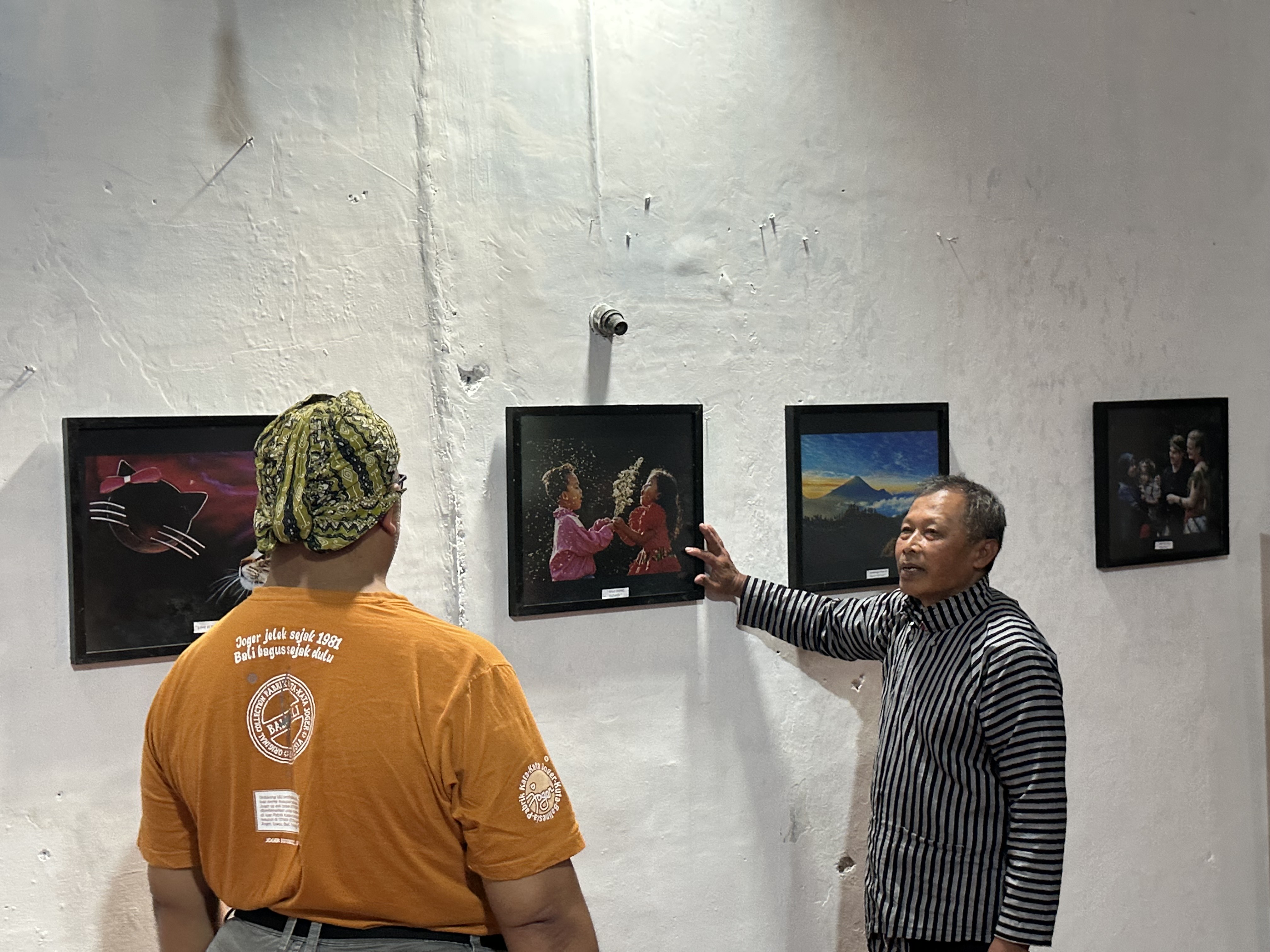 Fotografer Agung Wiera menunjukkan salah satu foto yang dipajang dalam pameran Rekam Jejak Mata Hati di Padepokan Esem Wonosobo.