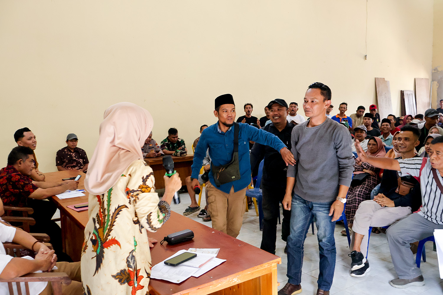 Perwakilan warga, Eri Wasono (tengah) mencoba menenangkan rekannya yang mulai tersulut emosi di hadapan Kepala Desa Sidorejo (kiri).