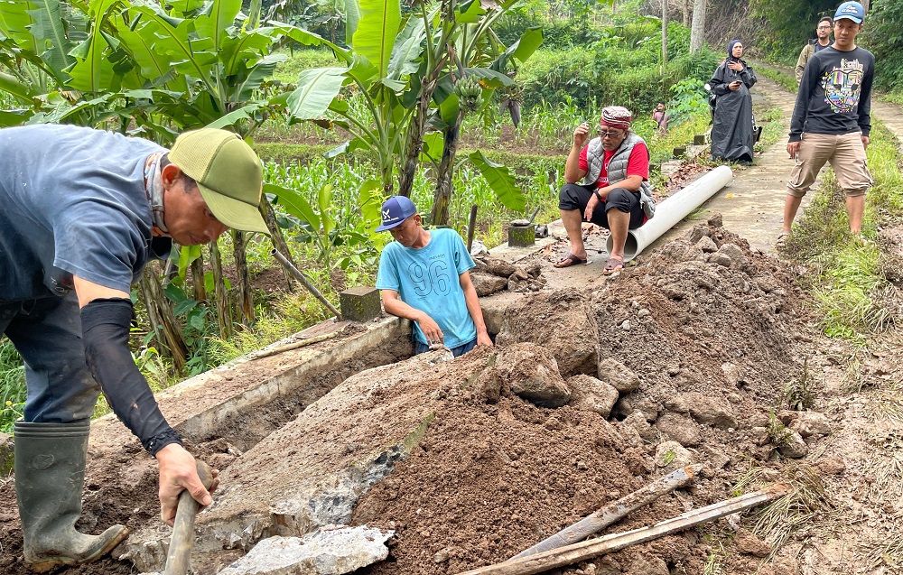 Bupati Temanggung Agus Setyawan (duduk) menunggui saat petugas berupaya memperbaiki kebocoran pipa PDAM di Desa Sunggingsari, Kecamatan Parakan.