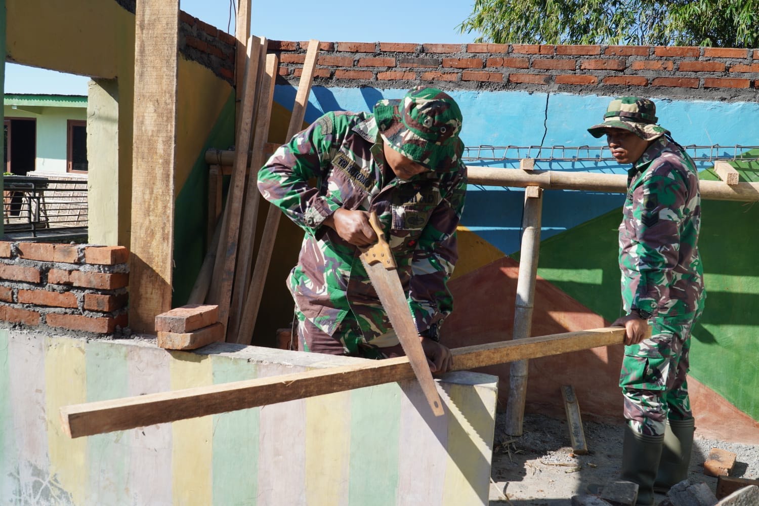 TNI dan warga Desa Banaran, Tembarak, Temanggung, gotong royong membangun pos kamling untuk meningkatkan keamanan dan ketertiban lingkungan.