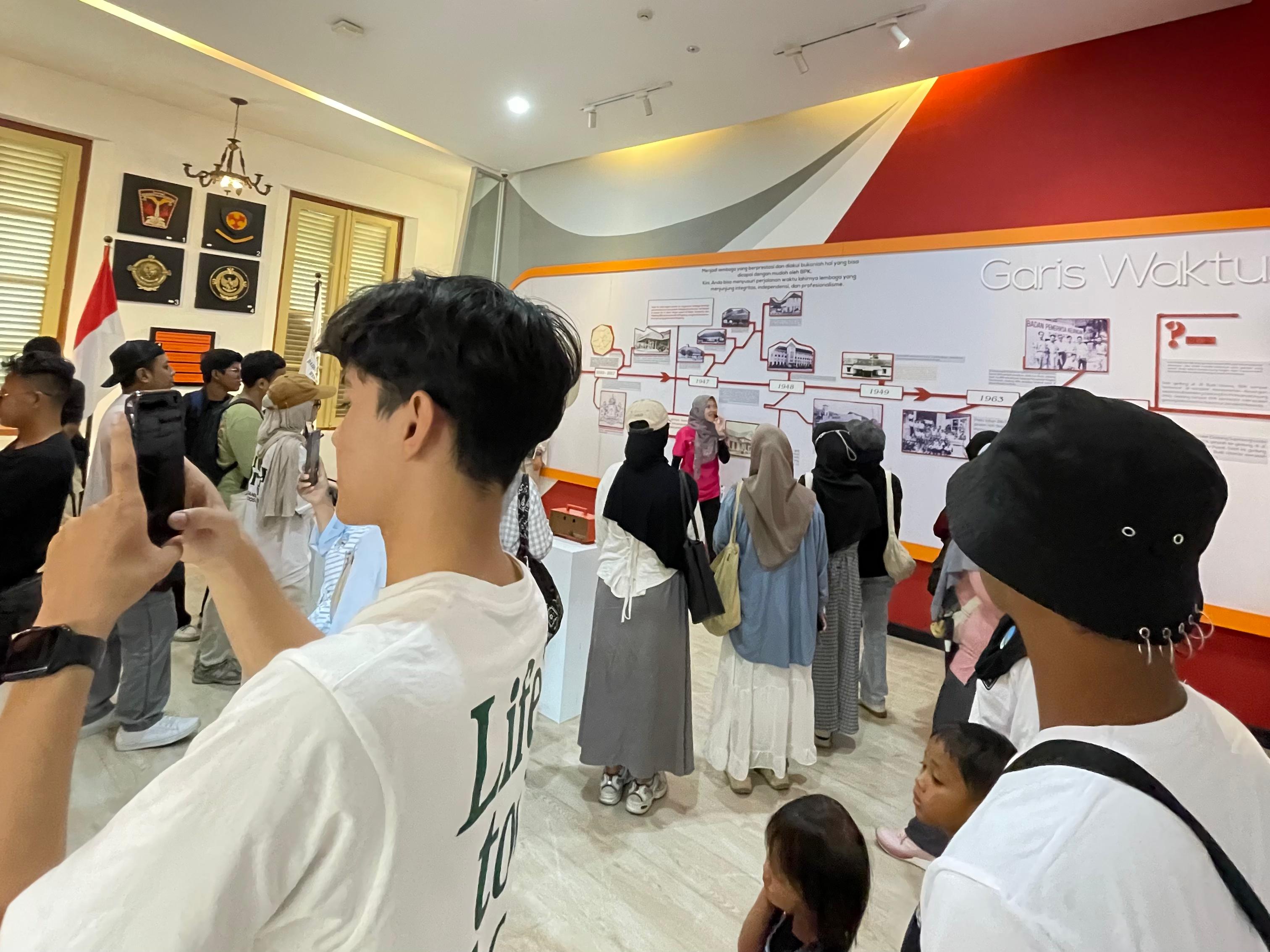 Peserta wisata gratis &ldquo;Ayo ke Magelang... Dolan Ro Jajan&rdquo; menyimak penjelasan pemandu saat mengunjungi ruang pamer di Museum BPK RI, Minggu (28/9/2025).