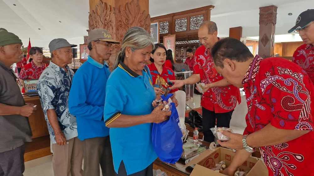 Para anggota Paguyuban Sosial Marga Tionghoa Indonesia (PSMTI) Kota Magelang memberikan sembako gratis, kue bolu kukus, dan kue keranjang.