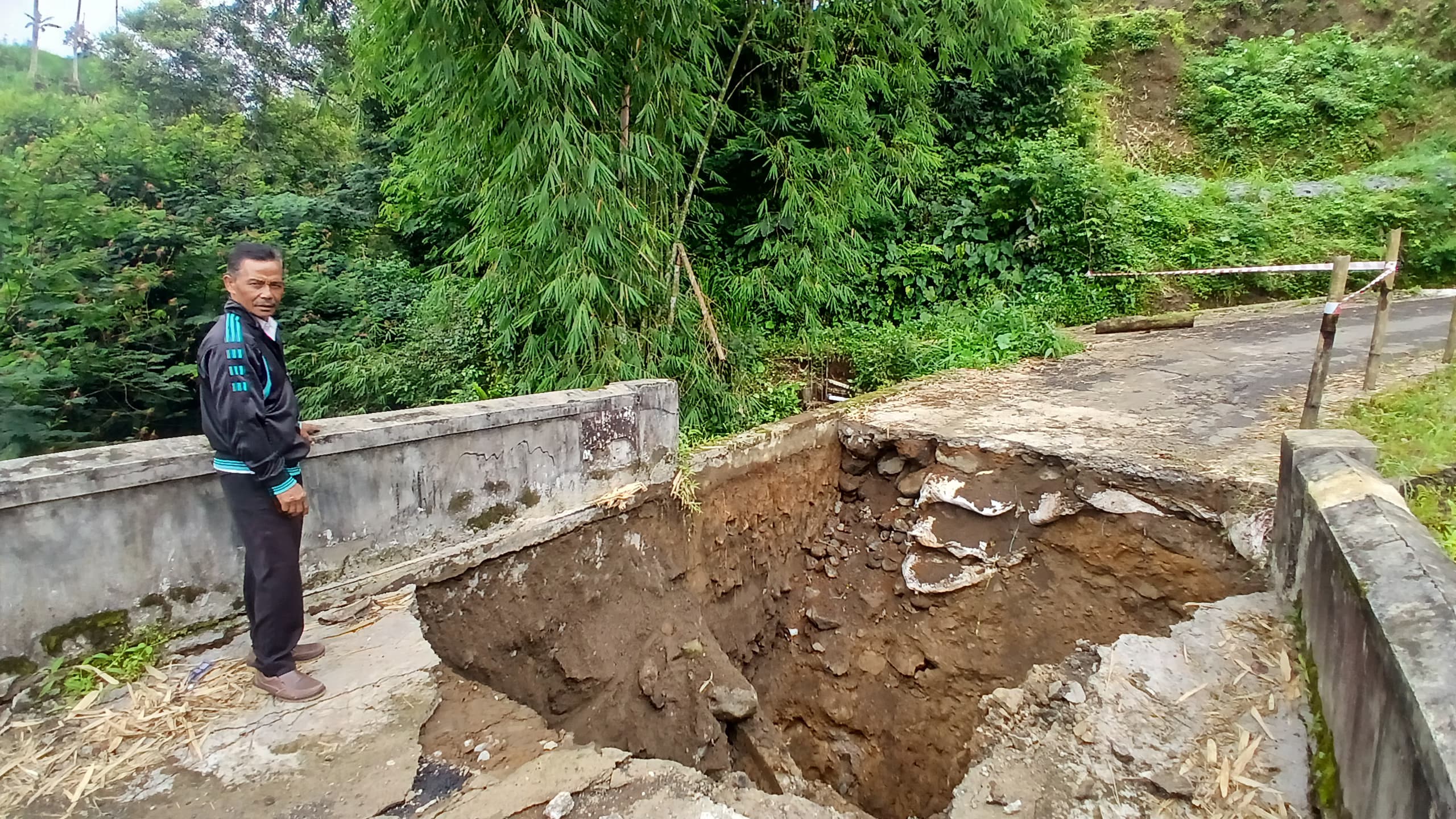 Warga Desa Kalikuning Kalikajar tak bisa melintasi jembatan karena ambles pada Selasa (17/2/2026) sore.