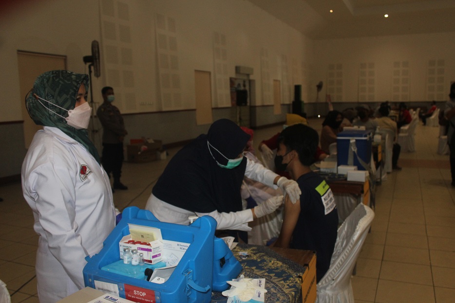 GENJOT VAKSIN : Vaksinasi yang diadakan Polres Magelang Kota, Rabu (30/3/2022) di Gedung Tri Bhakti Magelang. Pada kesempatan tersebut juga dibagikan sembako untuk masyarakat kurang mampu. (ROFIK SYARIF G P/RADAR MAGELANG)