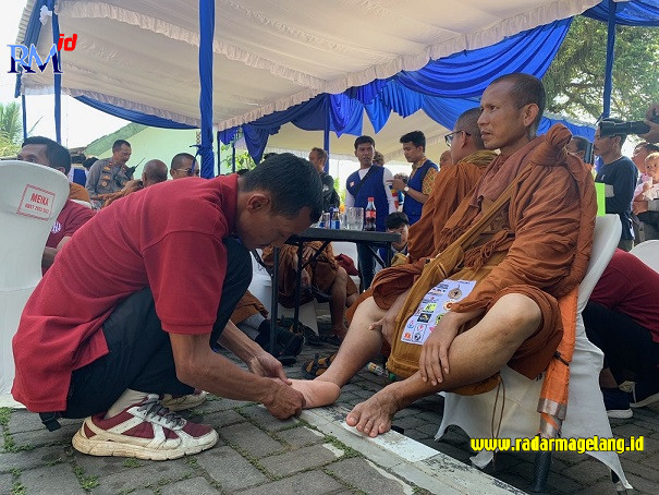 Biksu dipijat kakinya oleh terapis yang telah disiapkan oleh Polres Temanggung di Mapolsek Pringsurat, Selasa (30/5/2023). (ADDIN ALFATH/ JAWA POS RADAR MAGELANG)