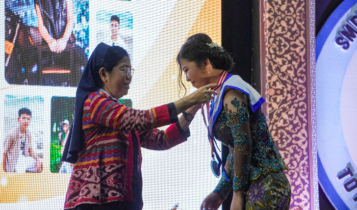 PROSESI WISUDA: Kepala SMPK Marfat Jember Sr Myram Juniati saat prosesi pengalungan gordon kelulusan siswa kelas XI tahun ajaran 2023/2024 di Ballroom Edelweiss Hotel Cempaka Jember, kemarin (12/4).