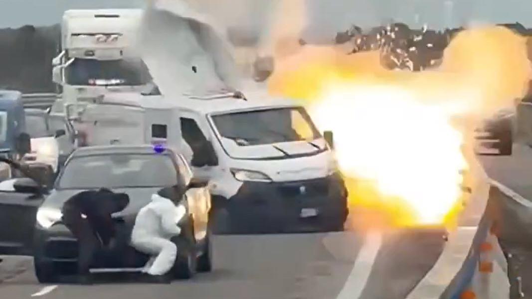 MENCEKAM: Perampok bersenjata lengkap yang menyamar sebagai polisi memblokade sebuah jalan raya di Italia dan meledakkan mobil pengangkut uang lapis baja dalam aksi perampokan (Istimewa)