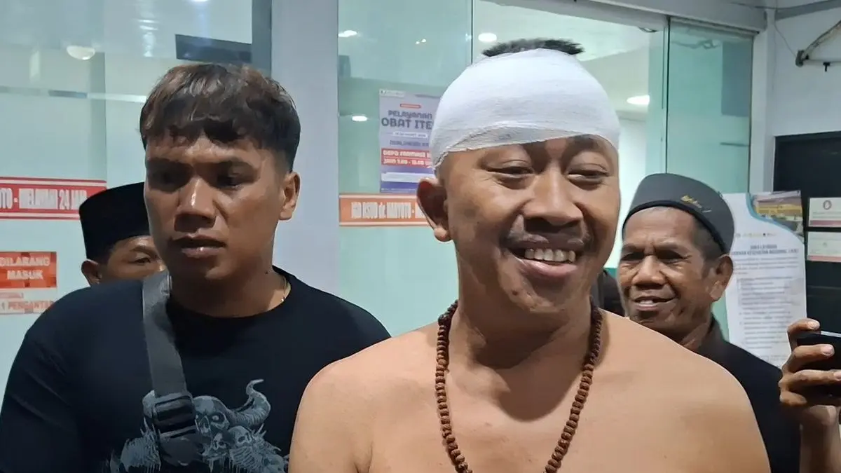 Kades Pakel Lumajang Sampurno keluar dari RSUD dr Haryoto setelah menerima perawatan. Ia meminta agar pelaku pembacokan dirinya tak ditahan Polres Lumajang. (Foto: Huda)