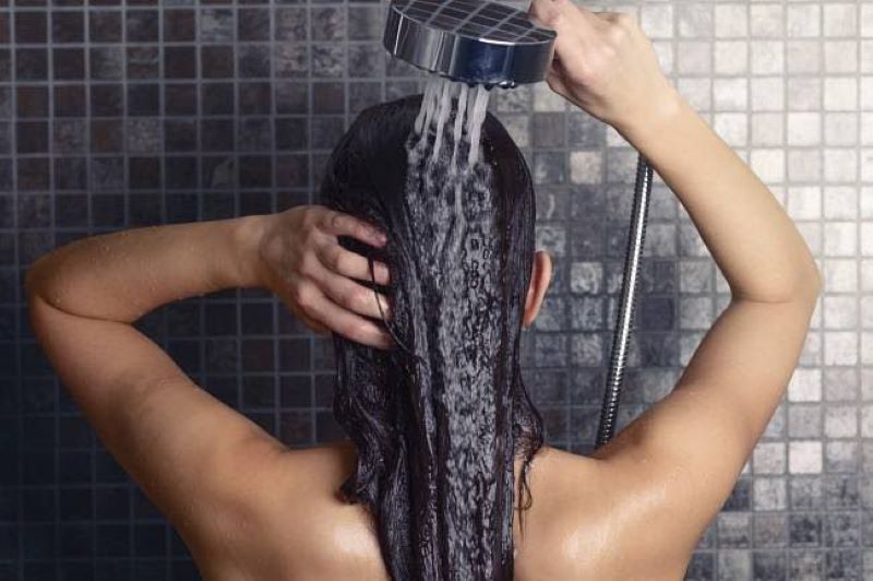 Ilustrasi wanita yang sedang mencuci rambut saat menstruasi. (website/halodoc)