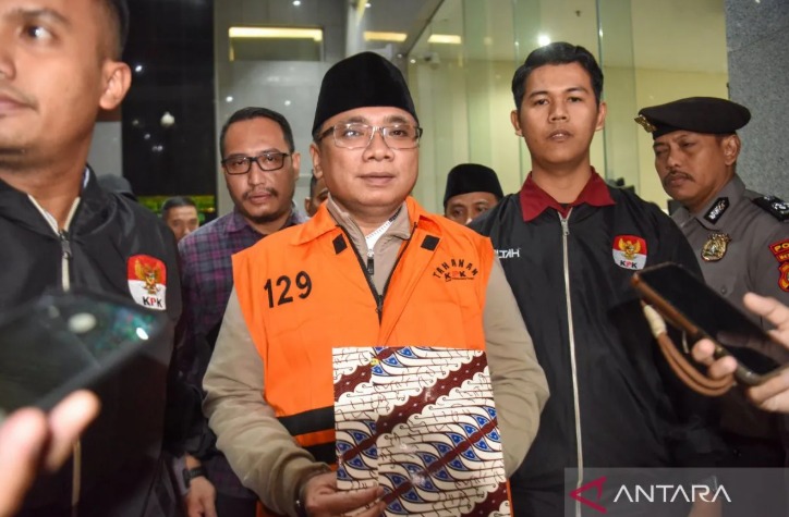 Tersangka kasus dugaan korupsi kuota haji dan penyelenggaraan ibadah haji Yaqut Cholil Qoumas (tengah) mengenakan rompi tahanan, Kamis (12/3/2026).