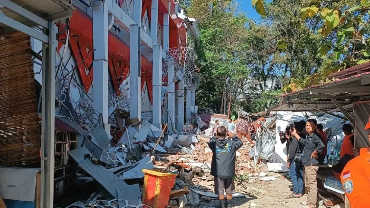 Sejumlah orang di dekat reruntuhan gedung KONI Sario Manado, Sulawesi Utara, pascagempa bumi, Kamis (2/4/2026). (ANTARA/Karel A Polakitan)