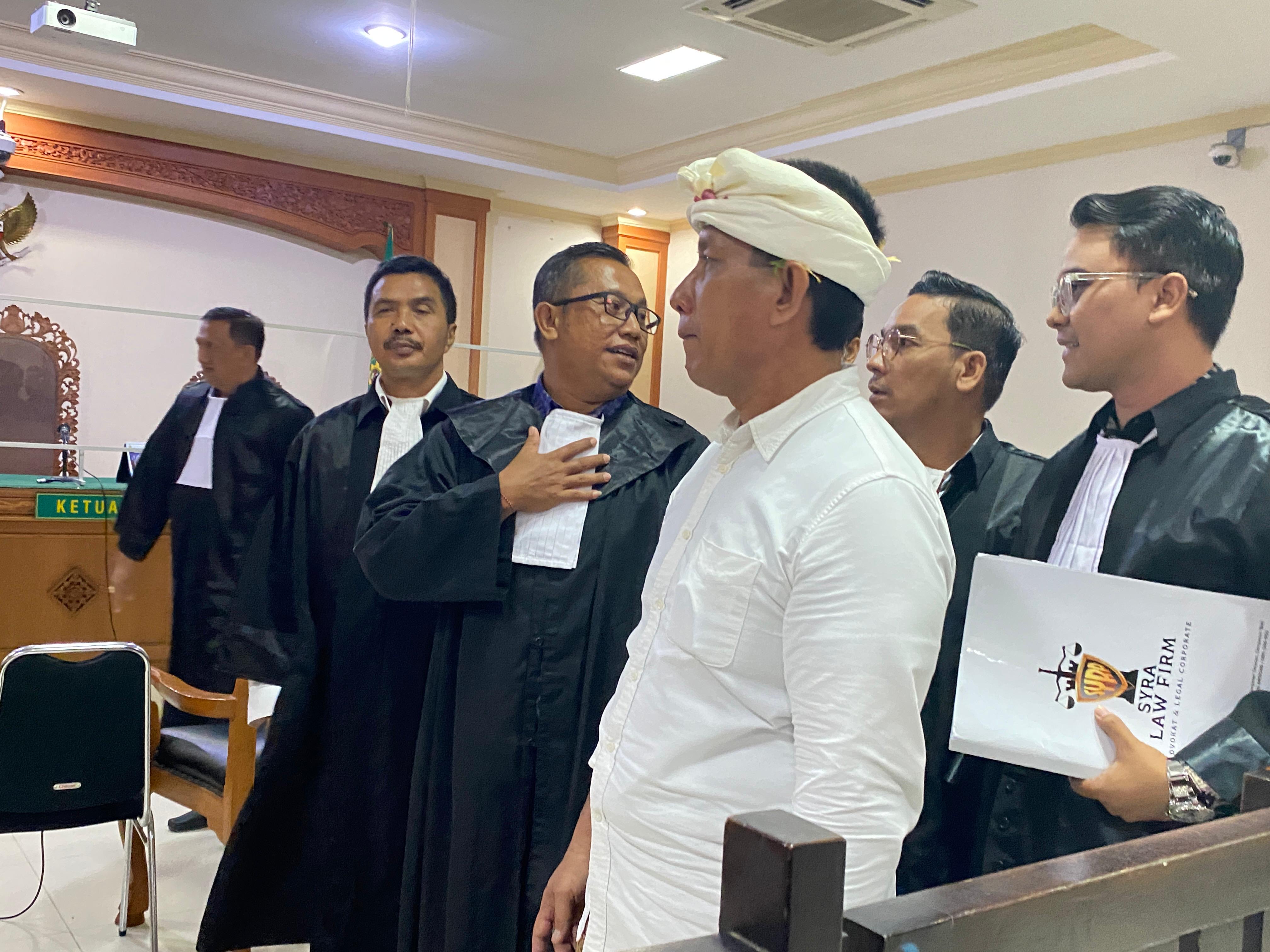 Terdakwa I Ketut Riana hadiri sidang perdana dengan mengenakan pakaian adat.