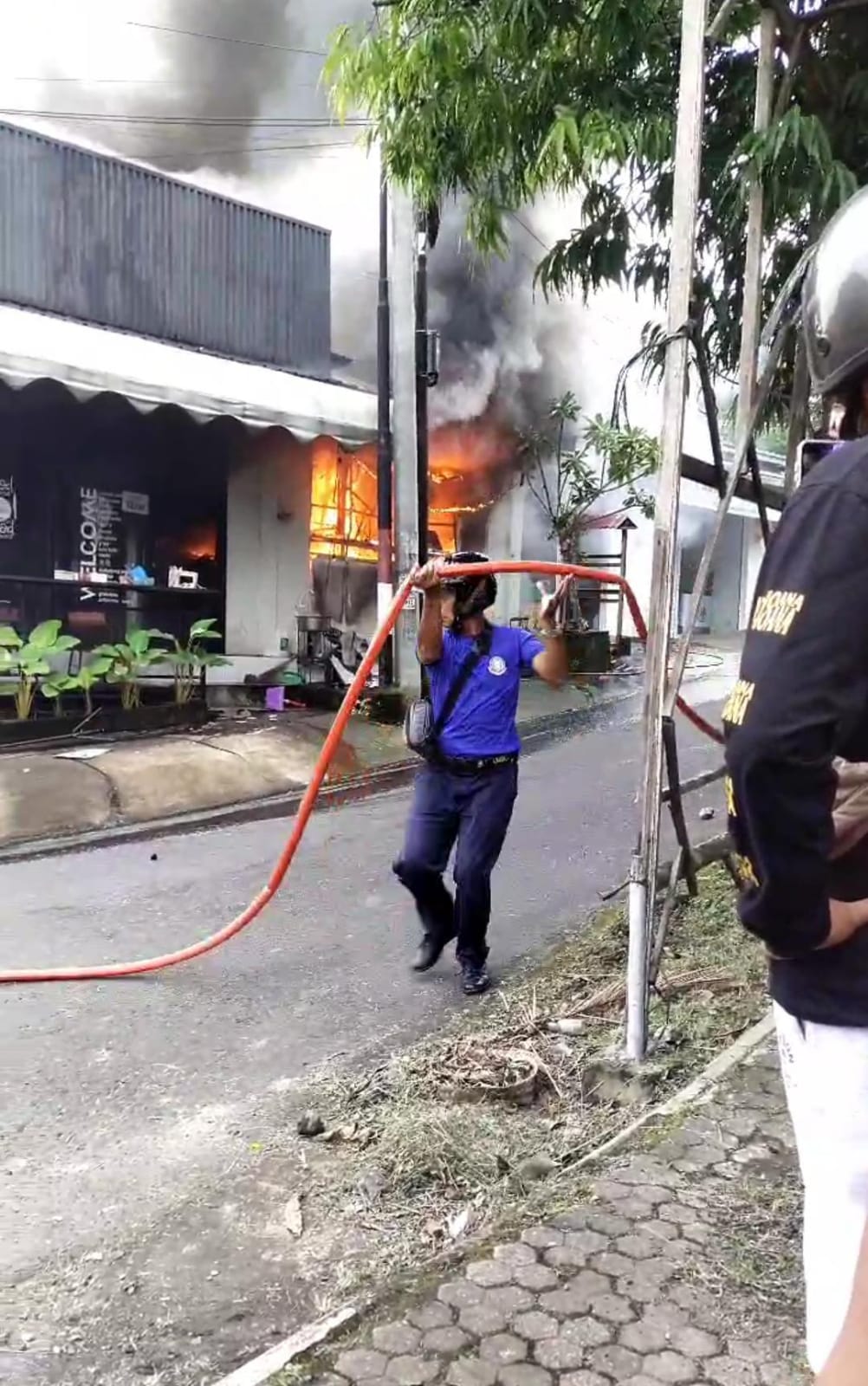 TERBAKAR : Petugas Damkar berupaya memadamkan api yang membakar resto pizza dan burger di Klungkung, Jumat (31/1/2025).