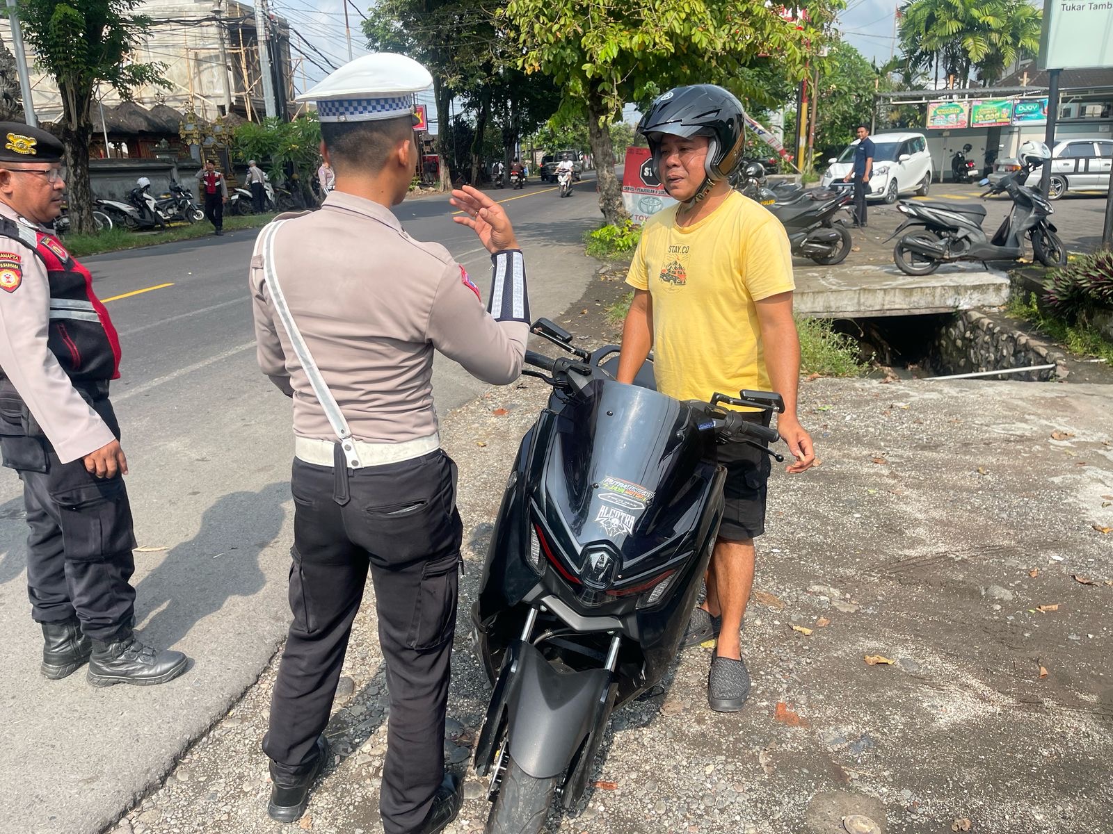 Petugas kepolisian melakukan pemeriksaan terhadap pengendara motor di Desa Dangin Tukadaya, Kecamatan  Jembrana, Kabupaten Jembrana.