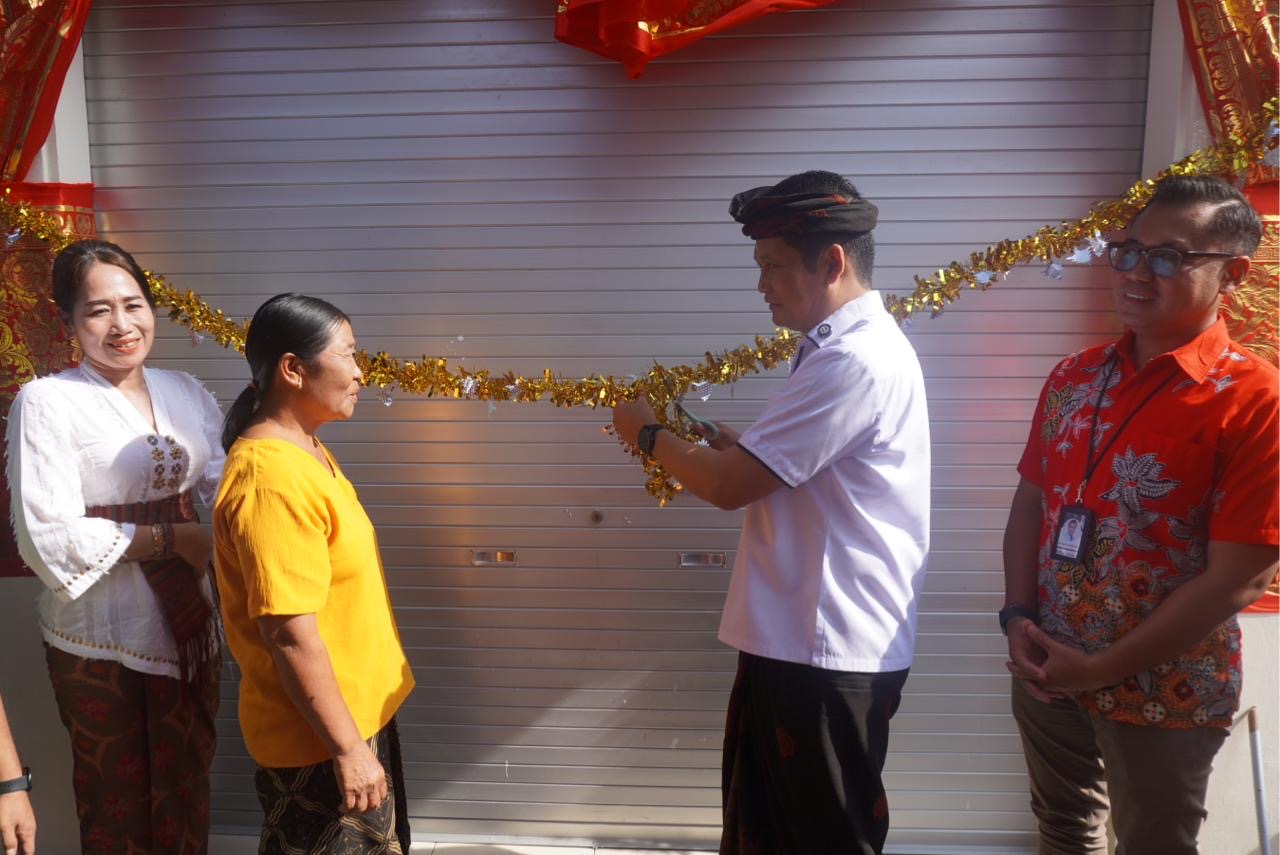 Bupati Jembrana I Made Kembang Hartawan saat menyerahkan bantuan bedah warung milik dadong Luh Sandat, di Desa Tegalbadeng Barat, Jembrana.