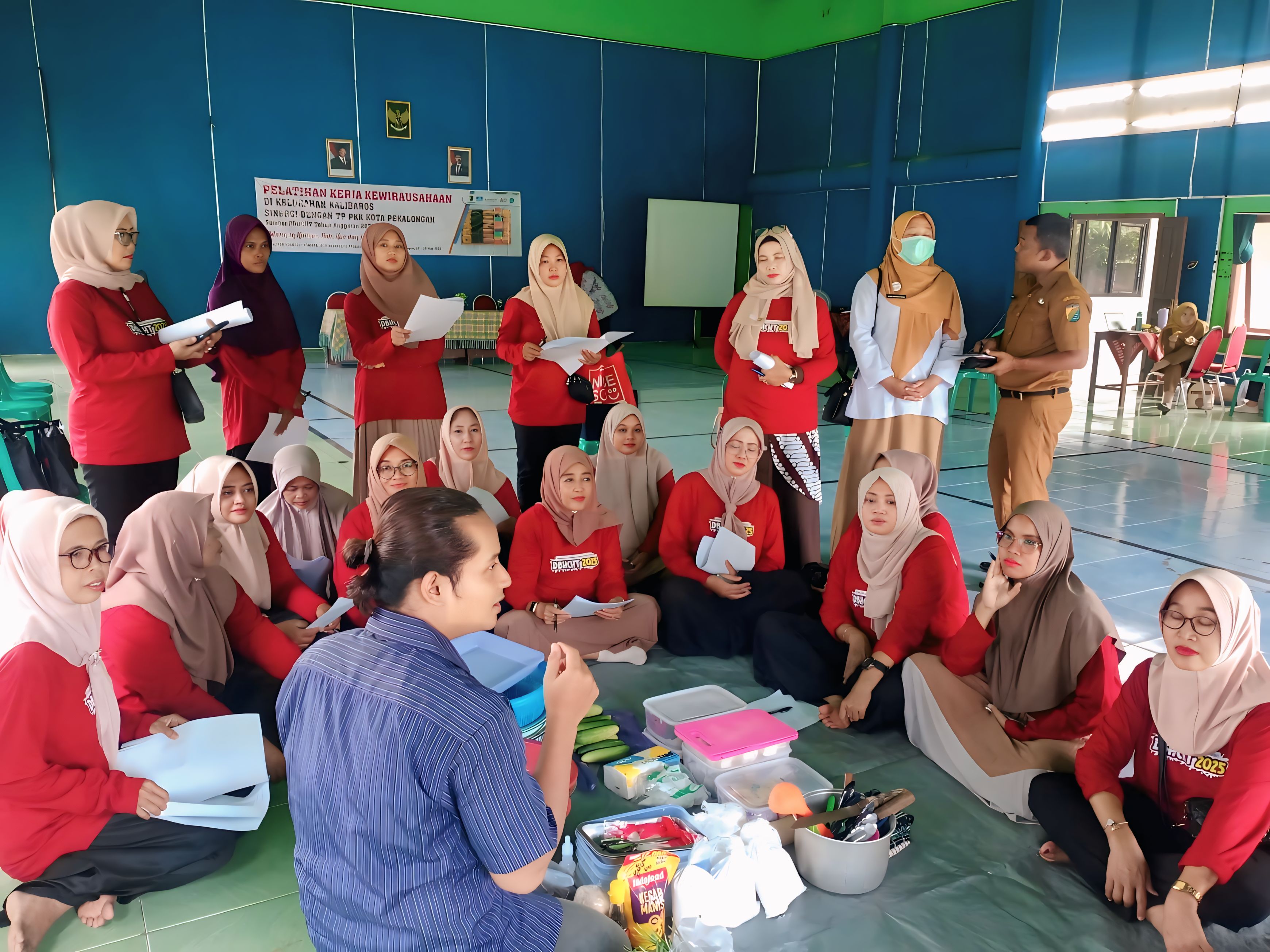 MENYIMAK - Peserta pelatihan menyimak paparan pelatih, sebelum praktek memasak di Aula Kelurahan Kalibaros, Selasa (27/5/2025).