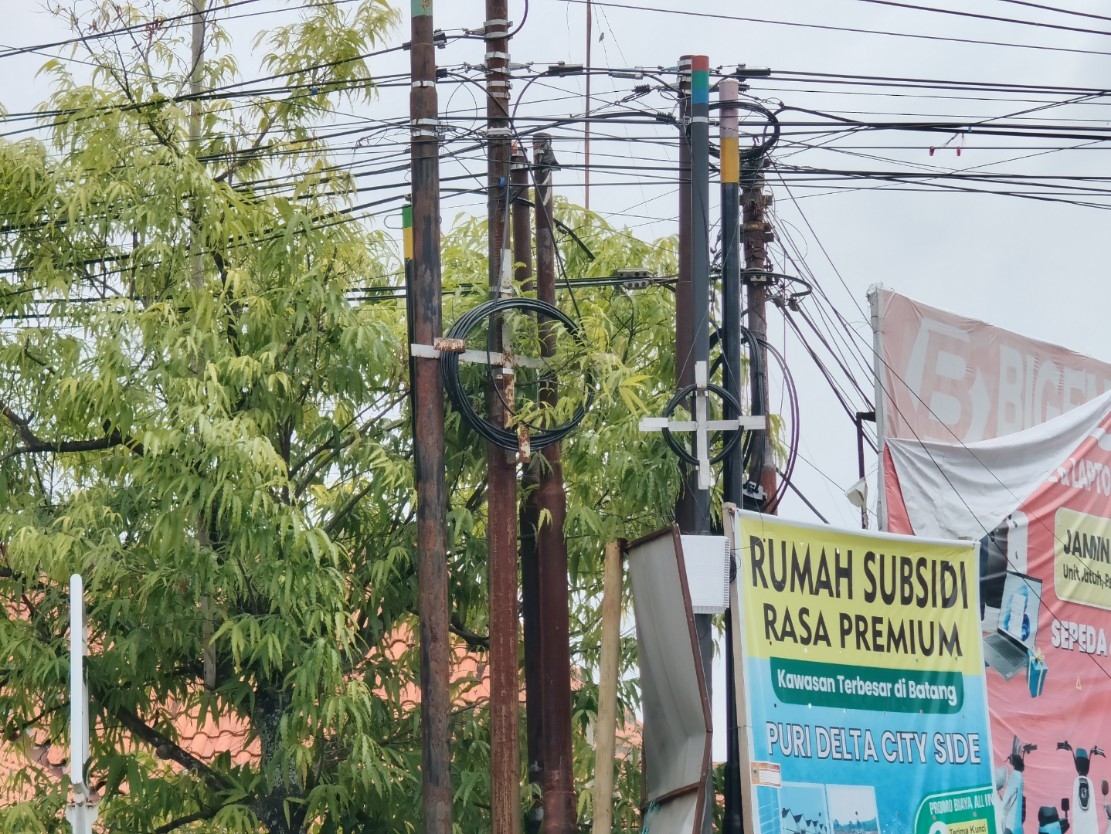 SEMRAWUT: Kondisi tiang-tiang dengan kabel semrawut di jalan Kabupaten Batang.