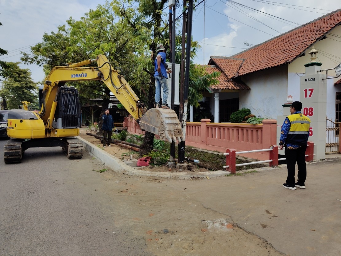 PENERTIBAN: Petugas saat melakukan pencabutan tiang-tiang internet yang ada di jalan Ahmad Yani.
