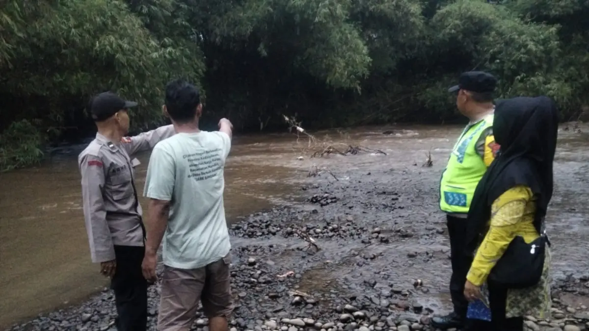 TENGGELAM : Anggota Polsek Batang meninjau lokasi kejadian bocah tenggelam di aliran Sungai Kramat. (DOK. POLRES BATANG)