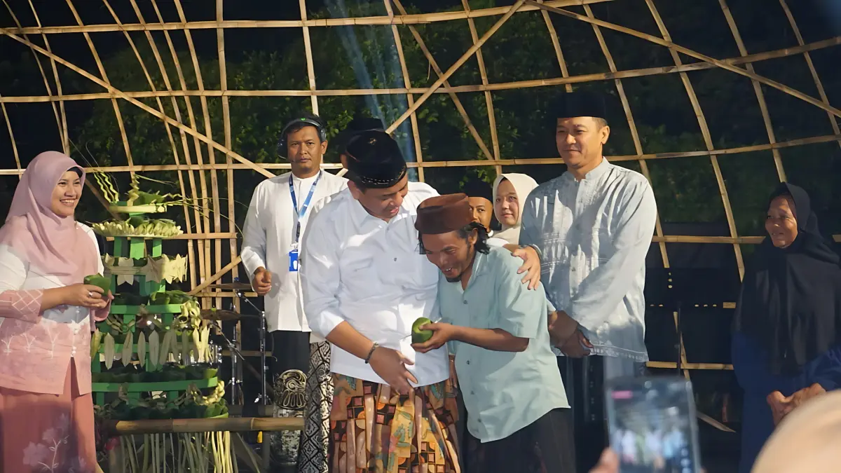 BAGI BUBUR : Walikota Pekalongan Aaf dan Kepala Pw BI Tegal, Bimala saat bagikan bubur suri kepada masyrakat langsung usai kirab 500 tangkir Bubur Suro, di Lapangan Leo Krapyak, Minggu (12/7/2026) malam.(Lutfi Hanafi./Jawa Pos Metro Pekalongan)