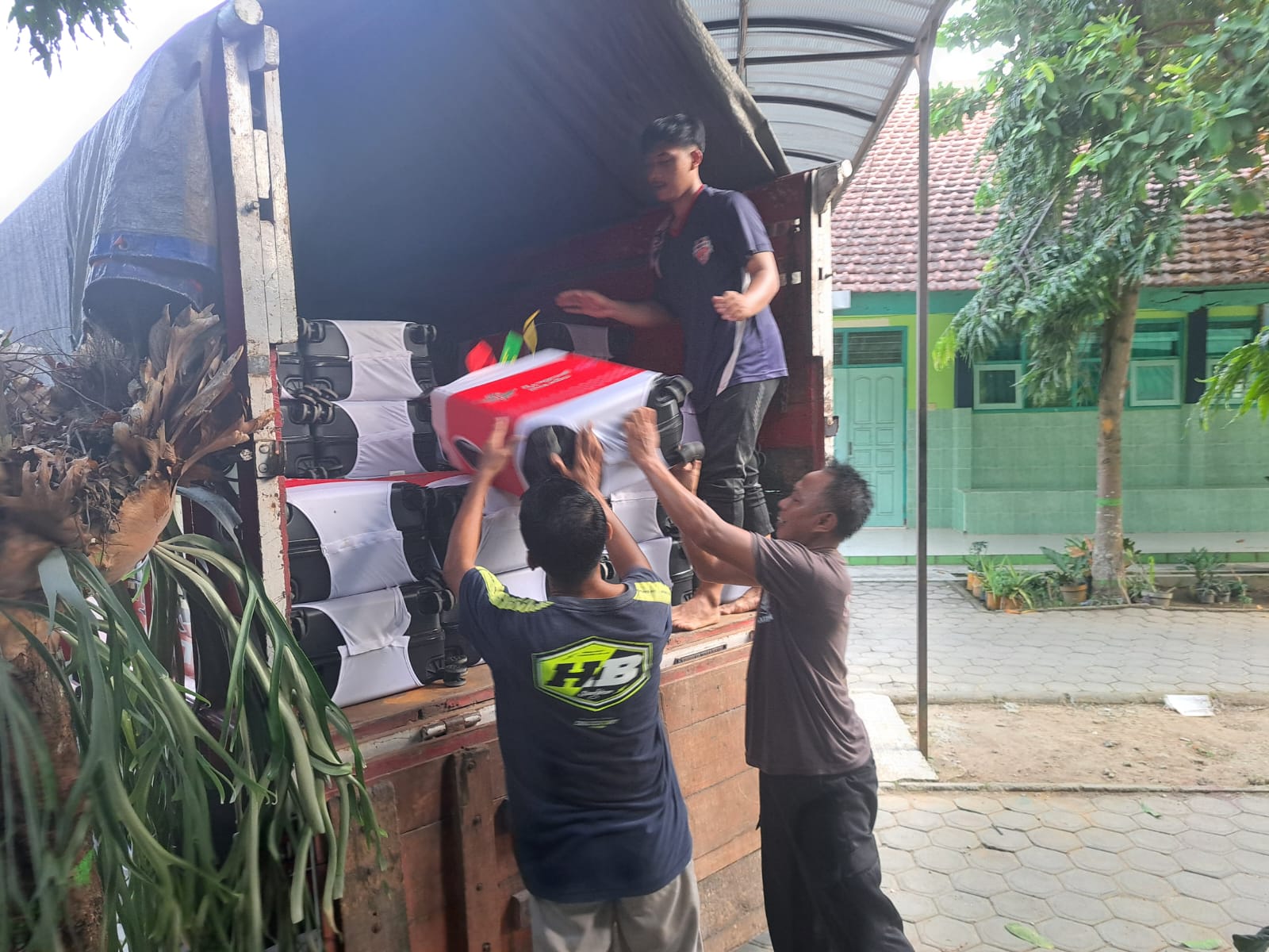 BEKAL: Petugas Kemenag Kabupaten Blitar memasukkan koper CJH di truk untuk diantar ke asrama haji Surabaya