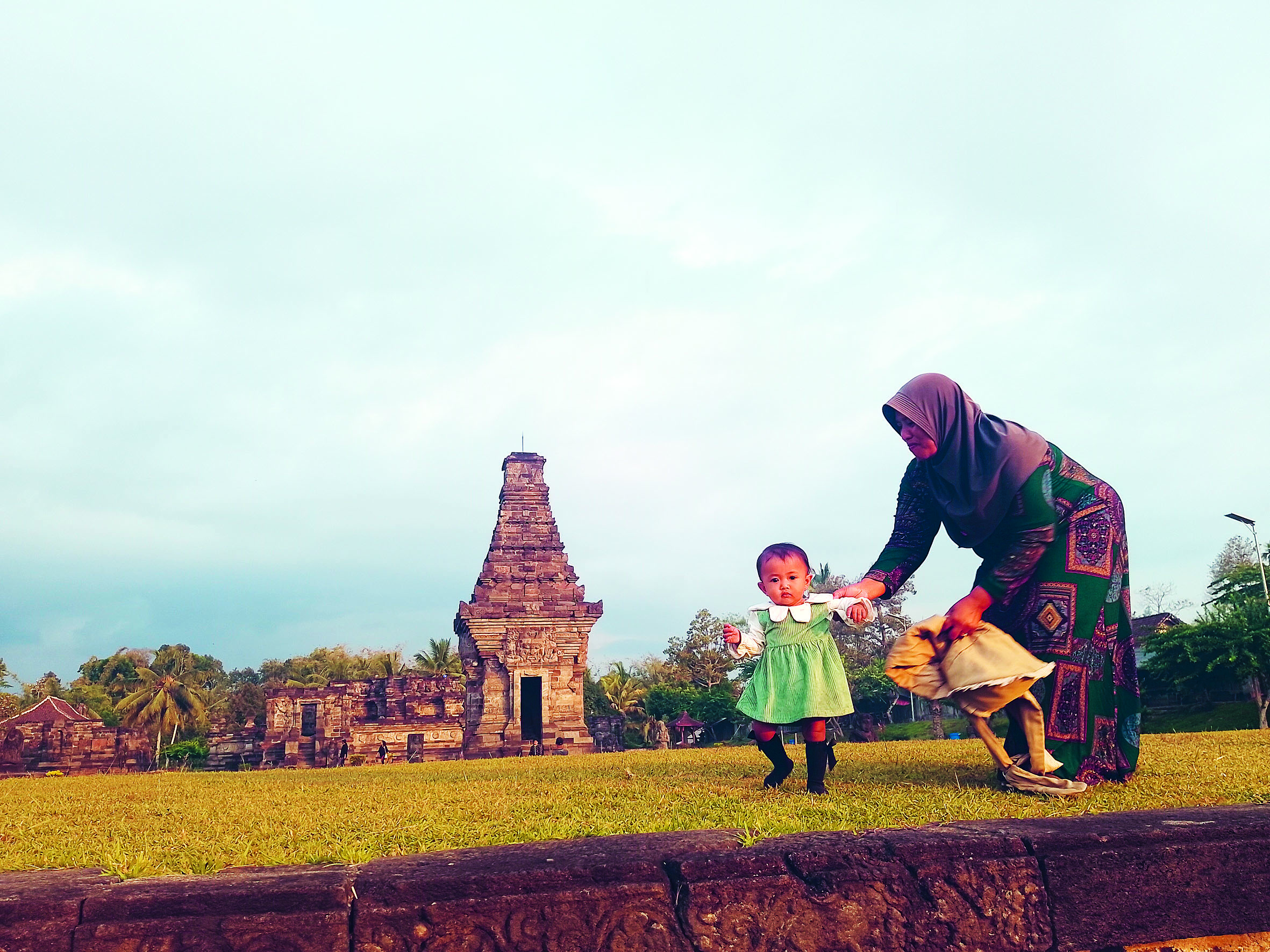 BAHAGIA: Seorang ibu bersama buah hatinya berlibur di Candi Penataran.