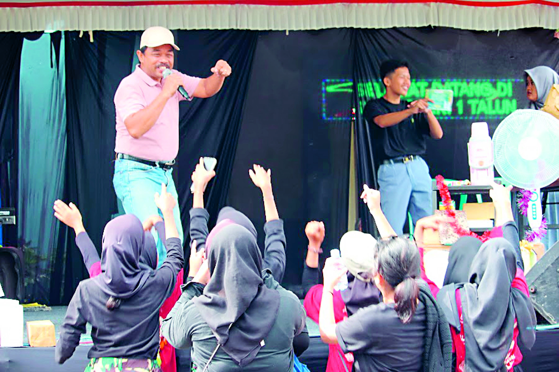 MERIAH: Kepala SMAN 1 Talun, Edy Sasmito, saat memberikan hiburan di halaman sekolah usai jalan sehat. (Kanan) Keluarga besar SMAN 1 Talun mengikuti kemeriahan jalan sehat pada Kamis (9/1).