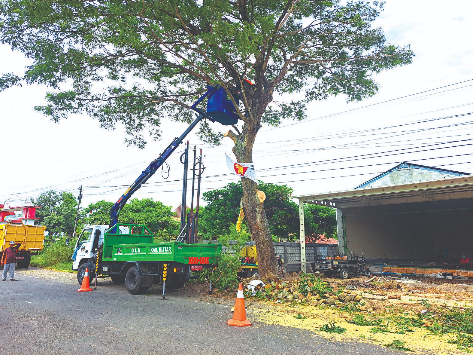 Petugas DLH Kabupaten Blitar memangkas pohon di Kelurahan Satreyan Kecamatan Kanigoro.