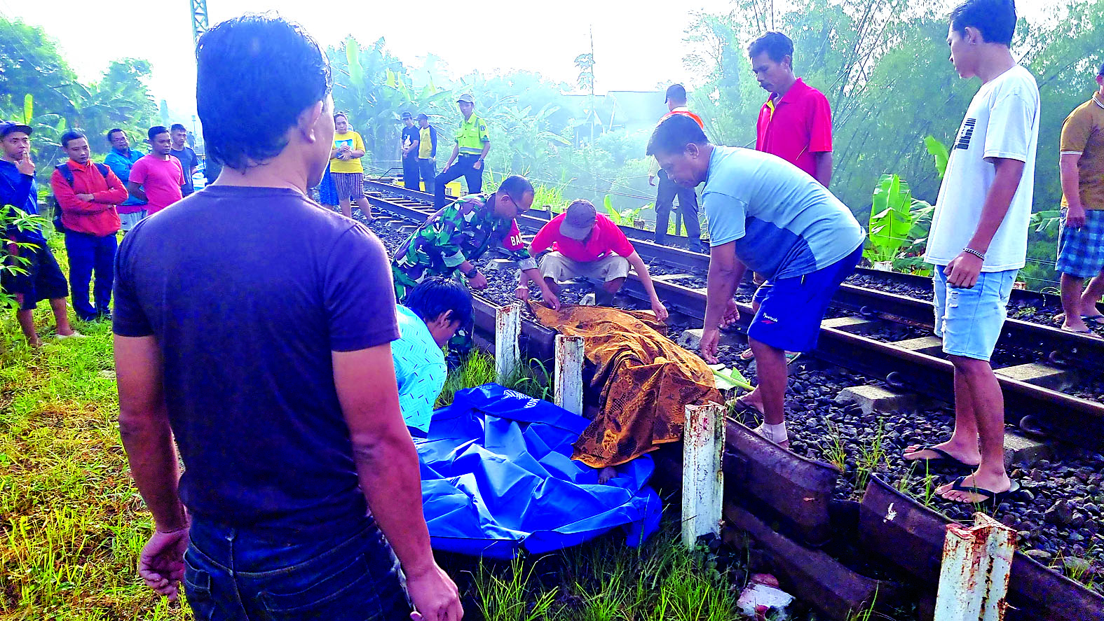 MENGENASKAN: Proses evakuasi jenazah SW di kawasan Stasiun Pohgajih, Kecamatan Selorejo, pada Selasa (18/2).