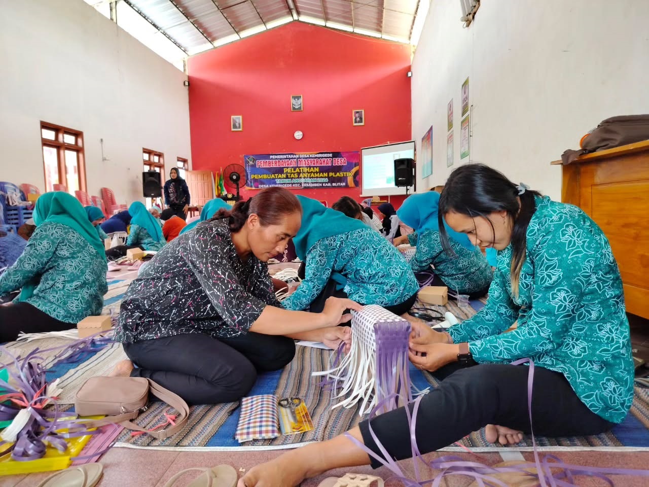 SIBUK: Belasan perempuan sedang membuat kerajinan. Pemerintah berencana membangun koperasi desa merah putih yang kemungkinan memiliki banyak unit usaha.
