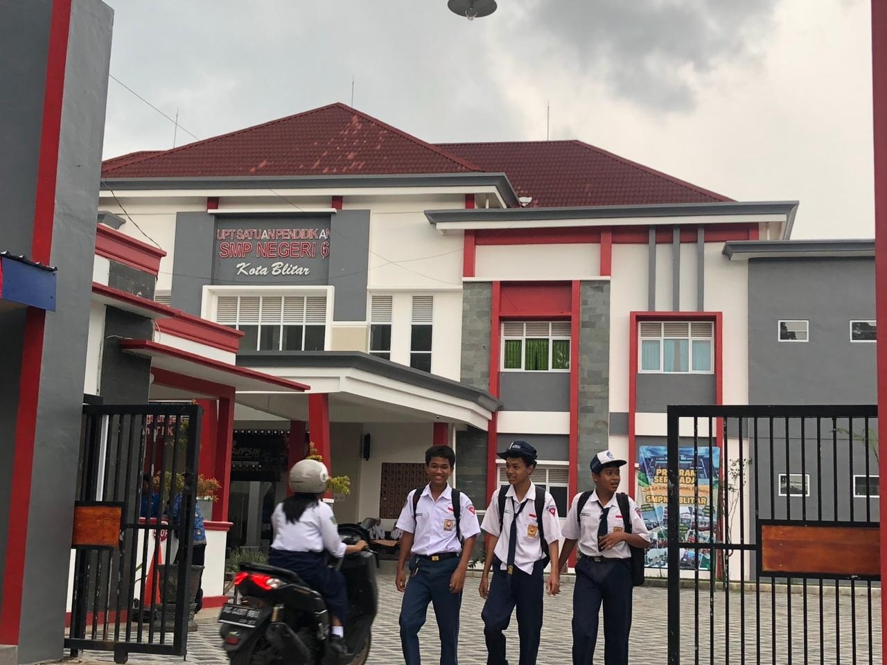 RAMPUNG: Siswa keluar dari gedung SMPN 6 Blitar saat jam pulang sekolah, Jumat (14/11/2025).