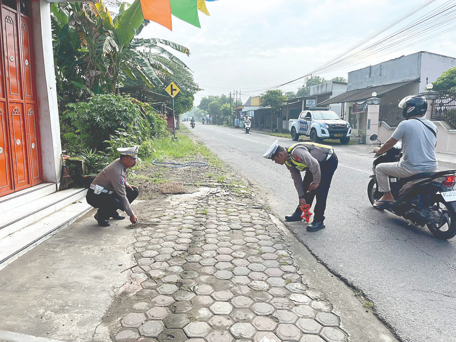 Satlantas Polres Blitar Kota saat memeriksa TKP tabrak lari di Srengat. Polisi Identifikasi Pelaku Tabrak Lari  &lrm;Disinyalir Mobil Ada di Tulungagung