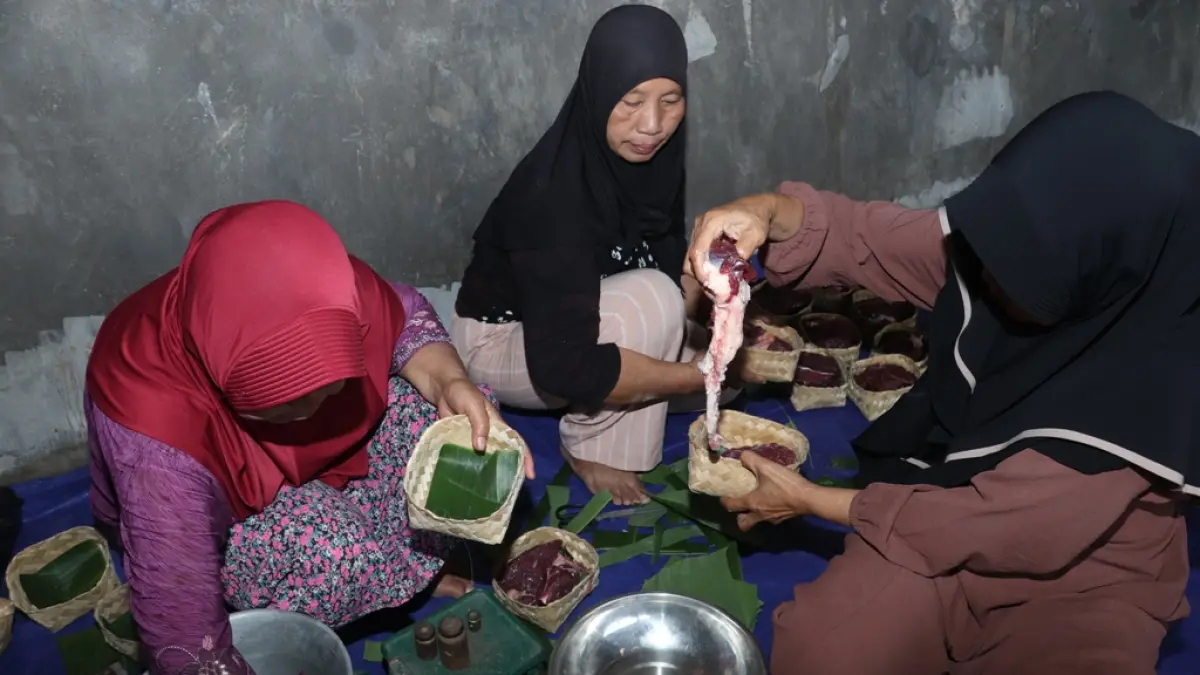 FAJAR RAHMAD AW/RADAR BLITAR
TRADISIONAL: Takmir Masjid Syaikh Subakhir membagikan daging kurban menggunakan wadah besek.
